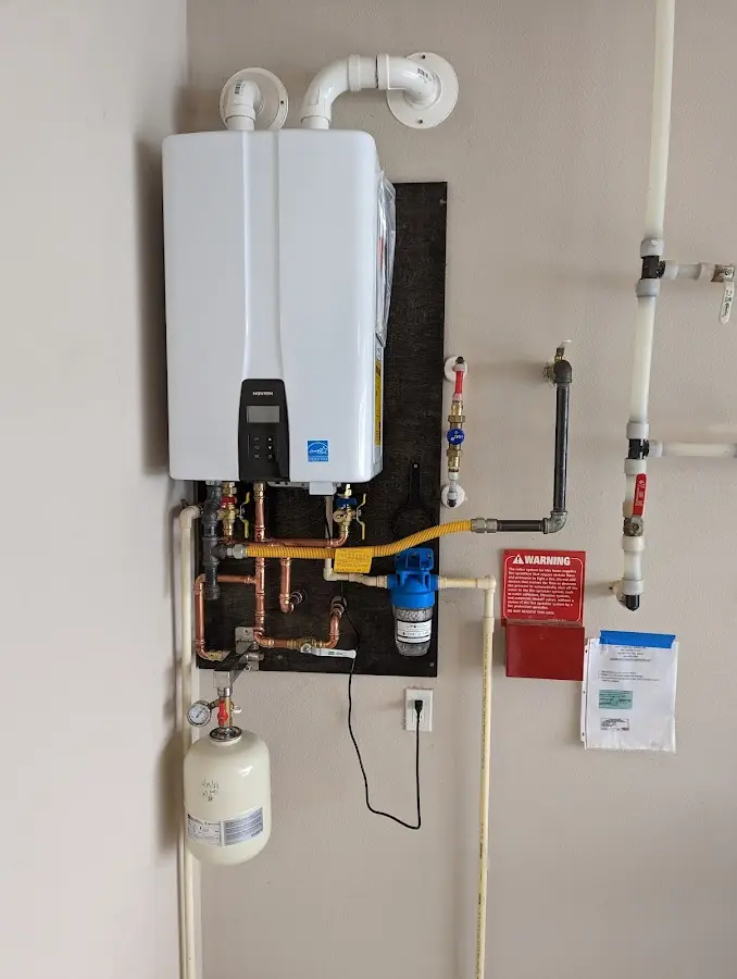 Professional plumber installing copper piping in a Florence-Graham home